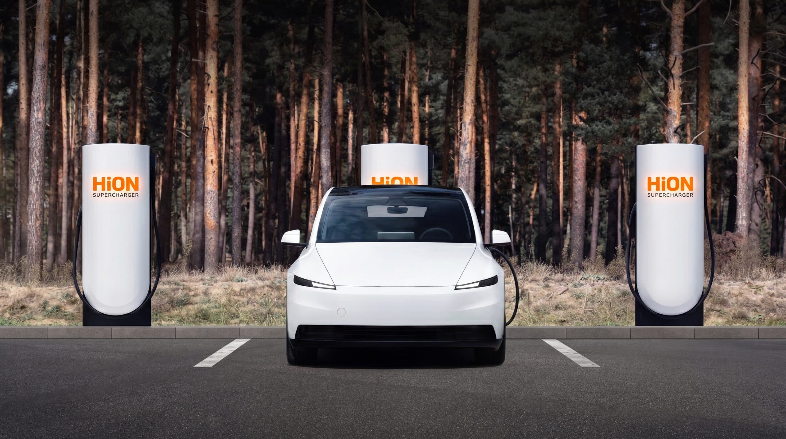 A white EV parked between HiON pillars on a forest pull-off, each matte-white face marked with the glowing orange HiON wordmark.