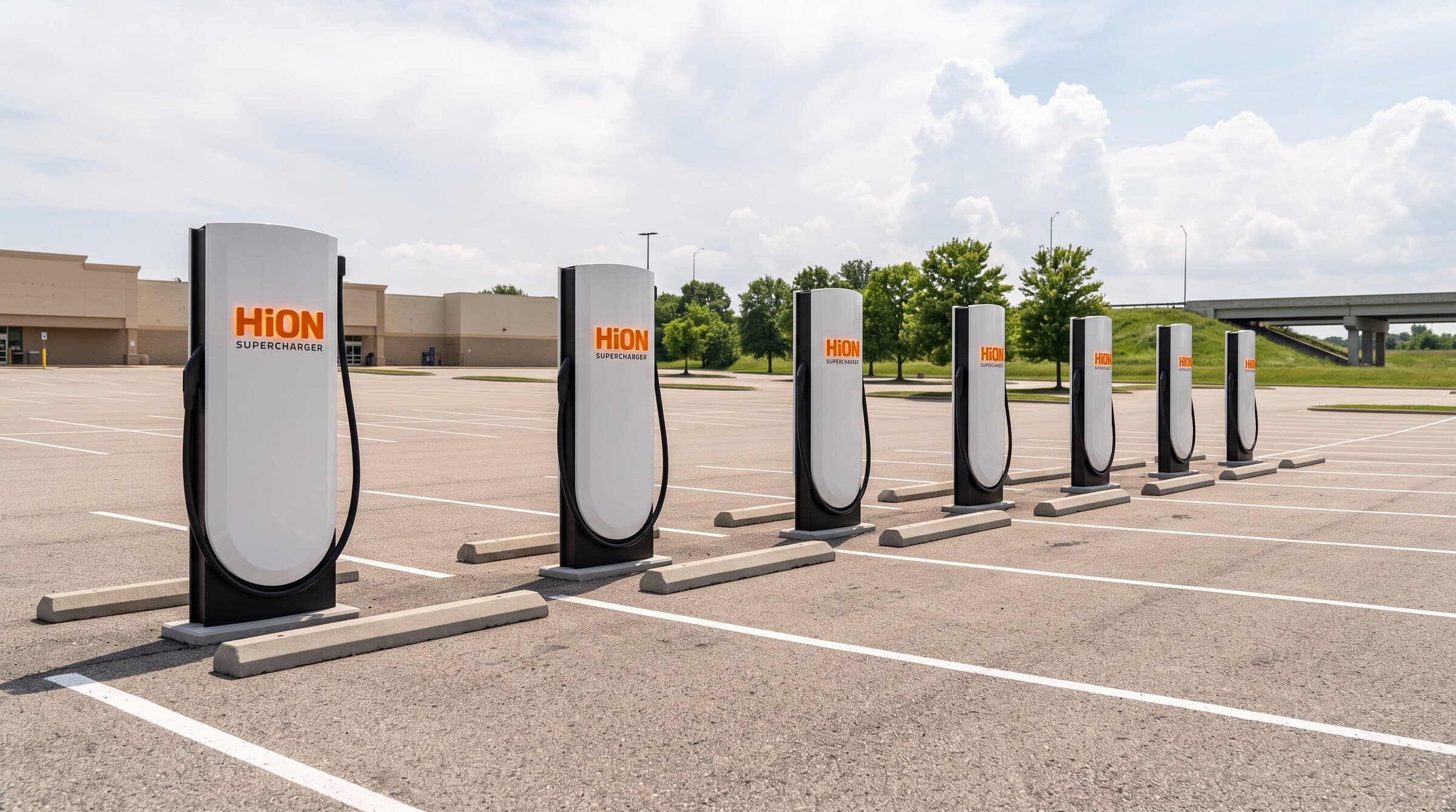 Rendering of HiON pillars in a wide Illinois retail lot beside the interstate — matte-white, each with the glowing orange HiON wordmark, bays empty and no vehicles present. Brand imagery, not a photograph of this station.